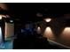 A basement home theater with an 'Exit' sign over the doorway, and a bar beyond the recliners at 11780 Pebblepointe Pass, Carmel, IN 46033