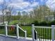 Scenic backyard view from the deck, showcasing mature trees and lawn at 12043 N Berling Dr, Mooresville, IN 46158