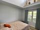 Cozy bedroom with a slanted ceiling, a comfortable bed, and a large window with natural light at 12043 N Berling Dr, Mooresville, IN 46158