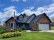 Charming single-Gathering home featuring a brick exterior, attached garage, and well-maintained lawn with mature landscaping at 12043 N Berling Dr, Mooresville, IN 46158