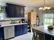 Beautiful kitchen featuring stylish blue cabinets, stainless steel appliances, and bright white countertops, a chef's dream at 12043 N Berling Dr, Mooresville, IN 46158