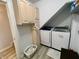Functional laundry room featuring a side-by-side washer and dryer, storage cabinets, and practical layout at 12043 N Berling Dr, Mooresville, IN 46158