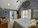 Vaulted ceiling bedroom with a large bed, dresser, and ample natural light from the window and glass patio door at 12043 N Berling Dr, Mooresville, IN 46158