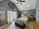 Bedroom featuring vaulted ceiling, large bed, lots of windows and decor, and wood-look floors at 12043 N Berling Dr, Mooresville, IN 46158