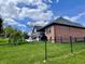 Brick home featuring a rear deck and manicured lawn at 12043 N Berling Dr, Mooresville, IN 46158