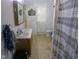 Modest bathroom featuring a sink, vanity, toilet, and shower with a striped shower curtain at 121 Lake Hart, Mooresville, IN 46158