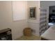 Modest bathroom featuring a window, decorative painting, a towel basket, and a shower with a striped shower curtain at 121 Lake Hart, Mooresville, IN 46158