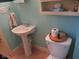 Bathroom featuring pedestal sink, updated toilet, and decorative fixtures at 121 Lake Hart, Mooresville, IN 46158