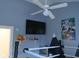 bedroom with blue walls, wrestling ring-themed bed, ceiling fan, and anime-themed posters at 121 Lake Hart, Mooresville, IN 46158