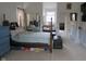 Spacious bedroom with a large bed, mirrored closet doors, and a sliding glass door with a window unit air conditioner at 121 Lake Hart, Mooresville, IN 46158