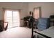 Spacious bedroom featuring sliding glass doors, carpeted floor, and traditional furniture including a blue dresser at 121 Lake Hart, Mooresville, IN 46158