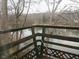 A wooded view of a lake taken from a wooden deck overlooking the water at 121 Lake Hart, Mooresville, IN 46158