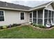 Home exterior featuring screened porch and manicured lawn at 1316 Long Shore Dr, Indianapolis, IN 46217