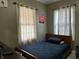 Bedroom with a bed covered by a blue quilt and natural light from the window at 1337 N Olney St, Indianapolis, IN 46201