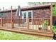 An expansive wooden deck with an outdoor table and chairs and string lights offers backyard living at 1355 Ash Ct, Martinsville, IN 46151