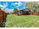 Well-maintained backyard featuring privacy fence, lush lawn, and mature landscaping at 1355 Ash Ct, Martinsville, IN 46151