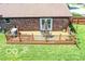 A spacious deck with dining area is attached to the brick house overlooking the landscaped backyard at 1355 Ash Ct, Martinsville, IN 46151