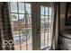 A view of a backyard with a deck from inside the house through double glass doors at 1355 Ash Ct, Martinsville, IN 46151