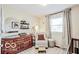 Bedroom featuring crib, recliner chair, decor, wood dresser and natural light at 1355 Ash Ct, Martinsville, IN 46151