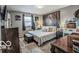 Bedroom features a queen bed, decorative wall art, dresser, and a vanity station at 1355 Ash Ct, Martinsville, IN 46151