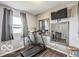 Bedroom with a treadmill, mounted television, wood flooring, and natural light at 1355 Ash Ct, Martinsville, IN 46151