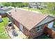 Aerial view of a charming single-story brick house with a spacious wooden deck and a well-manicured backyard at 1355 Ash Ct, Martinsville, IN 46151