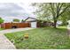 Ranch style home with an attached garage and a fenced yard on a sunny day at 1355 Ash Ct, Martinsville, IN 46151