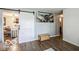 Cozy living room boasts a rustic barn door, hardwood floors, and unique aviation decor at 1355 Ash Ct, Martinsville, IN 46151