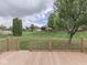 Large backyard, lush lawn, wood fencing, and mature trees from wooden deck at 1395 Heron Ridge Blvd, Greenwood, IN 46143