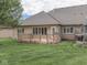 Well-manicured backyard and deck of brick home with an abundance of green space at 1395 Heron Ridge Blvd, Greenwood, IN 46143