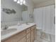 Double vanity bathroom with framed mirror, tiled floor, and shower with curtain at 1395 Heron Ridge Blvd, Greenwood, IN 46143