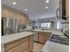 Well-lit kitchen with stainless steel appliances, an island, granite countertops, and an open layout to the dining room at 1395 Heron Ridge Blvd, Greenwood, IN 46143