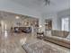 Spacious living room featuring hardwood floors, neutral decor, and an open layout to the kitchen and dining areas at 1395 Heron Ridge Blvd, Greenwood, IN 46143
