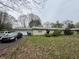 Single-story home featuring an attached garage and mature landscaping at 1532 Greer Dell Rd, Indianapolis, IN 46260