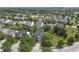 Aerial view of the home showcasing mature trees, a well-kept lawn, and neighborhood streets at 15936 Symphony Blvd, Noblesville, IN 46060