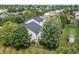An aerial view showcases a landscaped backyard with trees, a privacy fence, and neighborhood with mature trees at 15936 Symphony Blvd, Noblesville, IN 46060