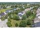 Overhead view of the neighborhood with mature trees, ponds, and well-maintained lawns at 15936 Symphony Blvd, Noblesville, IN 46060