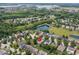Aerial view highlighting the home, lush greenery, and tranquil pond in the neighborhood at 15936 Symphony Blvd, Noblesville, IN 46060