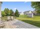 Spacious back deck with chairs overlooking a well-maintained, fenced backyard with mature trees and green lawn at 15936 Symphony Blvd, Noblesville, IN 46060