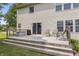 A home's backyard features a wooden deck with furniture and a sliding glass door entry into the home at 15936 Symphony Blvd, Noblesville, IN 46060