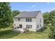 Aerial view of backyard with a wooden deck, grill, green lawn, privacy fence, and mature trees at 15936 Symphony Blvd, Noblesville, IN 46060