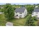 Aerial view of a large backyard with a deck, lush green lawn, mature trees, and a shed in a fenced yard at 15936 Symphony Blvd, Noblesville, IN 46060