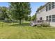 The backyard features a wooden deck, a large tree and a fenced in yard with green grass at 15936 Symphony Blvd, Noblesville, IN 46060