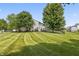 Well-maintained backyard with striped lawn and fencing, offering privacy and space at 15936 Symphony Blvd, Noblesville, IN 46060