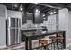 Finished basement wet bar featuring stainless fridge, cabinets, and bar top at 15936 Symphony Blvd, Noblesville, IN 46060