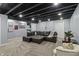 Finished basement living area with sectional sofa, carpet, and decor at 15936 Symphony Blvd, Noblesville, IN 46060