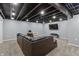 Finished basement living area featuring dark brown sectional sofa and television at 15936 Symphony Blvd, Noblesville, IN 46060