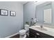 Well-lit half bathroom with dark wood vanity, modern fixtures, and contemporary decor at 15936 Symphony Blvd, Noblesville, IN 46060