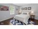 Comfortable bedroom with a queen-sized bed, stylish rug, and ample natural light from the window at 15936 Symphony Blvd, Noblesville, IN 46060