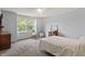 Cozy bedroom featuring soft carpet, a quaint rocking chair, and ample natural light from large windows at 15936 Symphony Blvd, Noblesville, IN 46060